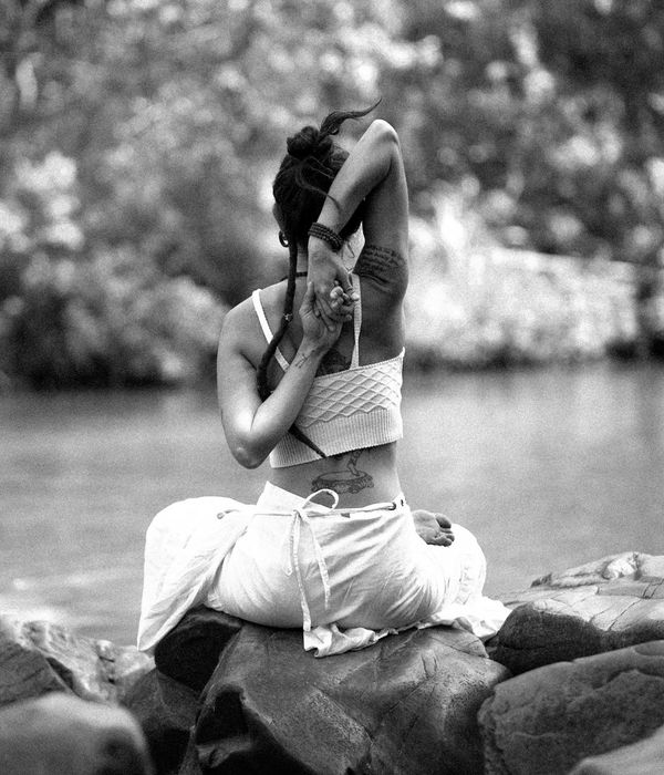 Woman in a calm, seated yoga pose, embodying harmony and balance.